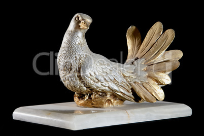 Classic painted gold marble statue of dove isolated on black background