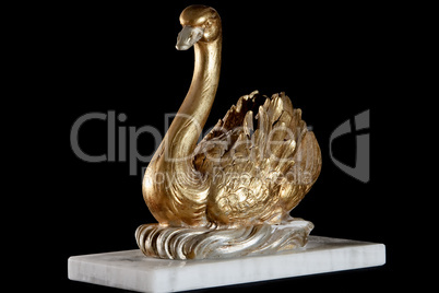 Classic painted gold marble statuette of swan isolated on black background