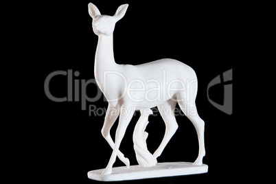 Classic white marble statuette of a deer isolated on black background