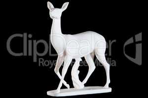 Classic white marble statuette of a deer isolated on black background