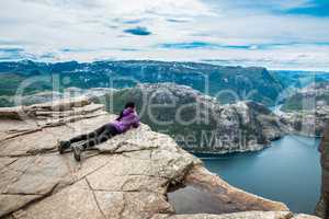 Prekestolen. Woman looking at the landscape from a height.