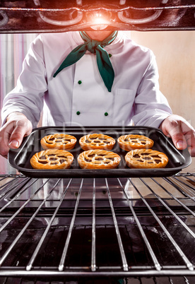 Chef cooking in the oven.