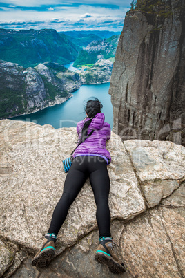 Prekestolen. Woman looking at the landscape from a height.