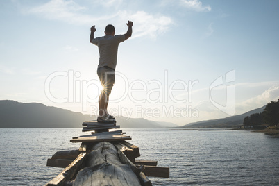 Boy in front of mountain lake