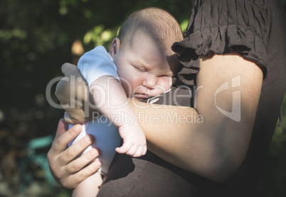 Baby in his mother's arms