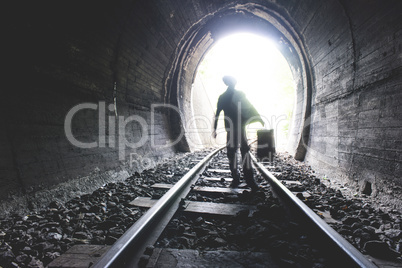 Child walking in railway tunnel