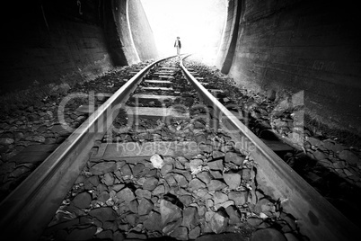 Child walking in railway tunnel