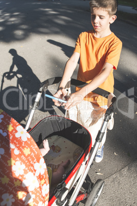 Child with smartphone taking a picture of baby.