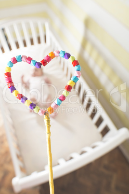 Baby in a bed in frame of heart shape