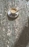 Cup of coffee on wooden table.