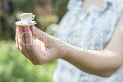 Hand hold small cup of coffee