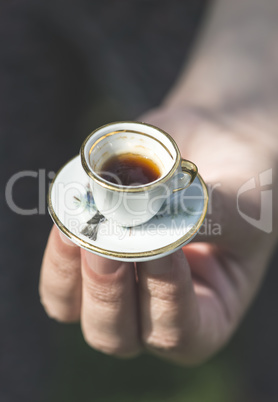 Hand hold small cup of coffee