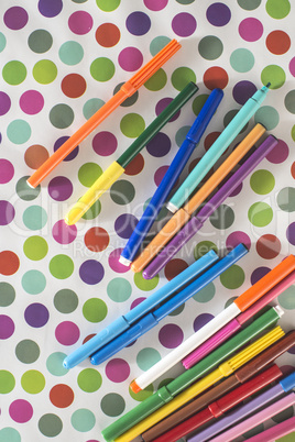 Pens on colorful background