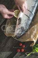 Preparing whole salmon fish for cooking