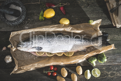 Preparing whole salmon fish for cooking
