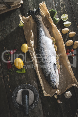 Preparing whole salmon fish for cooking