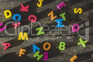 Multicolored wooden letters on vintage board