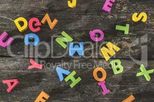 Multicolored wooden letters on vintage board