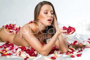 Young Woman And Rose Petals