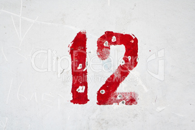 Number on weathered old white wall