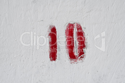 Number on weathered old white wall