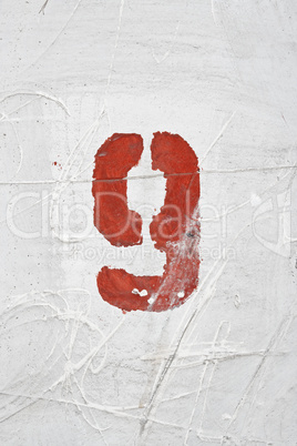 Number on weathered old white wall