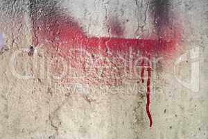 Weathered damaged wall with red paint