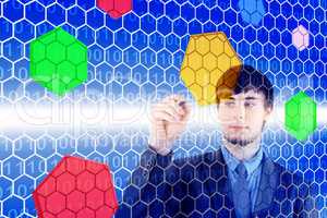 Young man in front of a virtual wall with colored hexagons