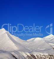 Snowy mountains and blue clear sky at nice morning