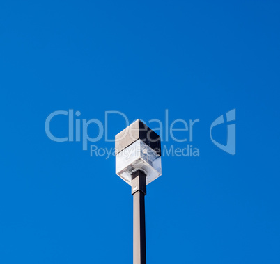 Square outdoor light on post on blue sky