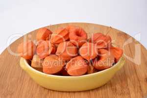 Red Physalis in a bowl  over white