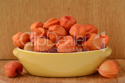 Red Physalis in yellow bowl