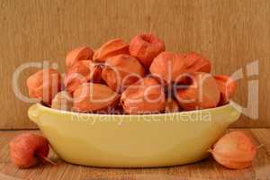 Red Physalis in yellow bowl