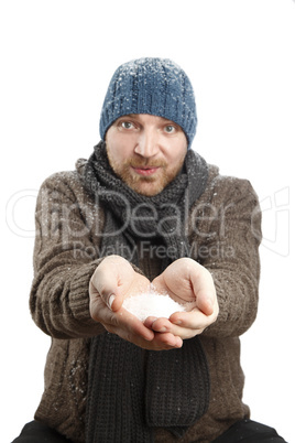 Portrait of an attractive man with snow in his hands