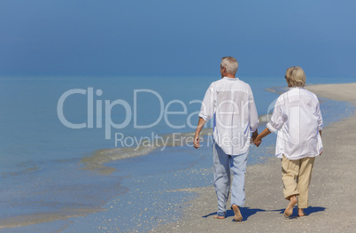 Senior Couple Holding Hands Walking on Beach