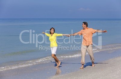 Happy Couple Running Holding Hands on A Beach