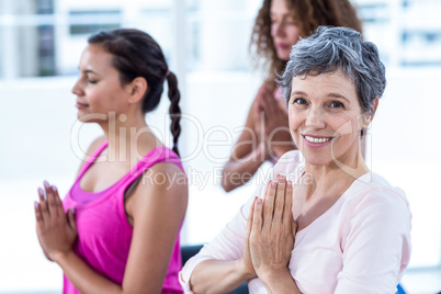 Portrait of happy woman with joined hands