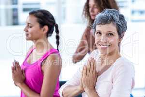 Portrait of happy woman with joined hands