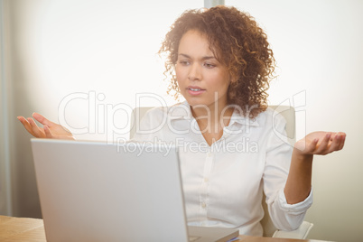 Businesswoman looking at laptop