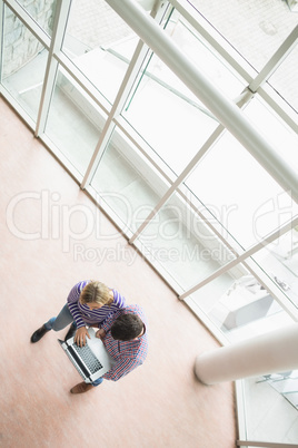 High angle view of college students using laptop