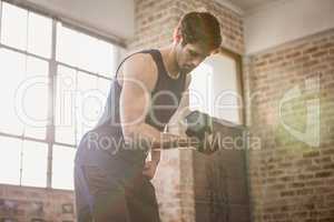 Man in sportswear lifting dumbbell