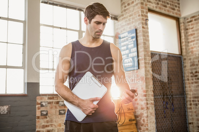 Instructor holding clipboard and stopwatch