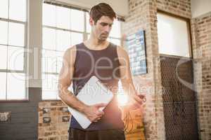 Instructor holding clipboard and stopwatch