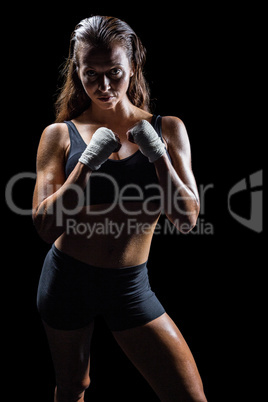 Portrait of female athlete with fighting stance