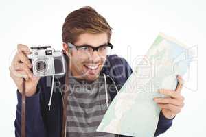 Portrait of happy man holding map and camera