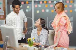 Happy business people using computer in office