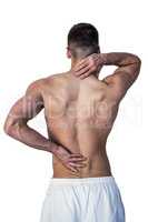 Rear view of man suffering from neck and back pain