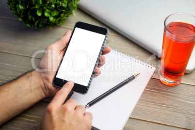 Person using smart phone at table