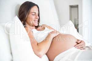 Happy woman relaxing on bed