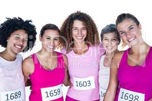 Portrait of smiling female athletes with arms around
